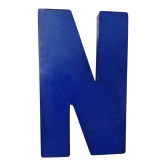 Letter N of vintage sign in blue plexiglass