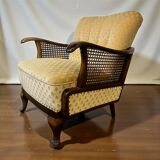 Vintage wooden armchair with rattan weaving.