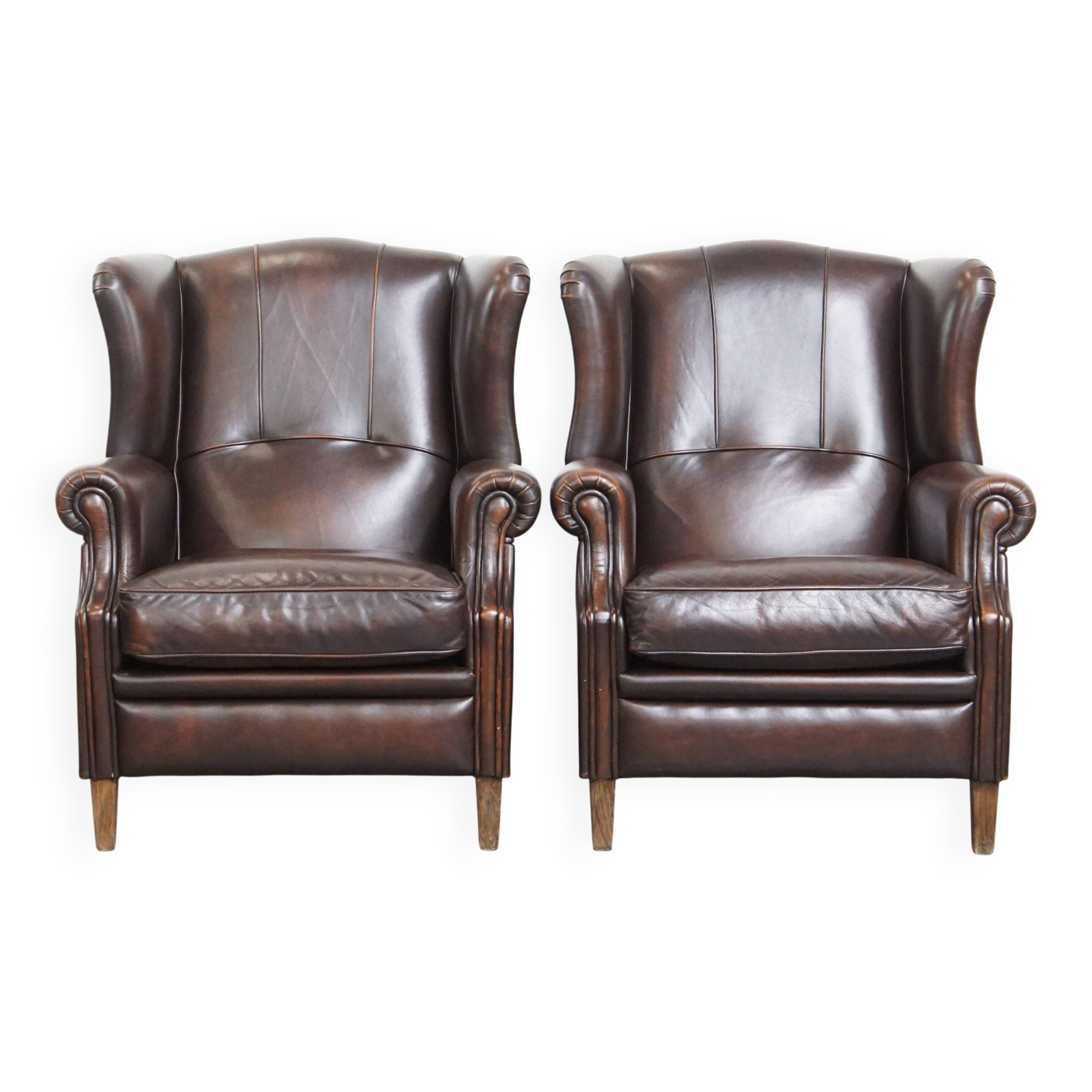 Comfortable and very beautiful set of 2 cow leather wingback armchairs in English style