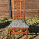 Set of 8 teak lounge chairs with high backs and zebra-striped seats