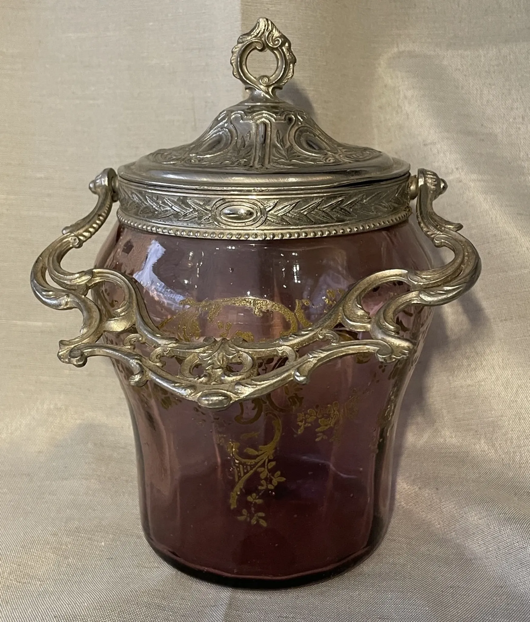 Purple glass biscuit barrel with painted gold arabesque decorations for cakes.