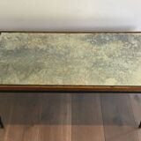 Patinated and gilded steel coffee table in the style of Jacques Quinet.