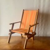 Old foldable beach seat in wood and canvas for children