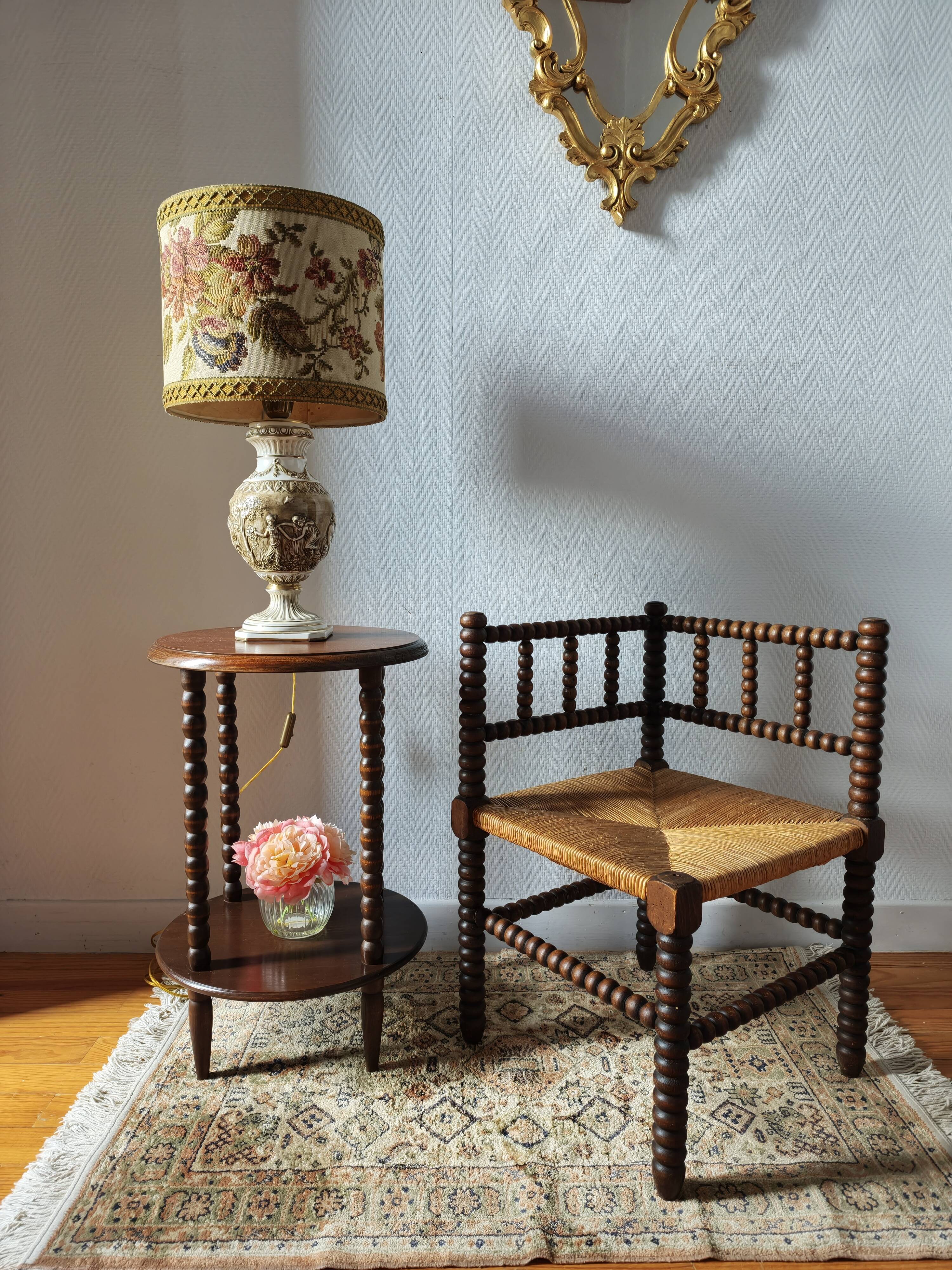 Old wooden turned spindle fireside chair with a straw seat.