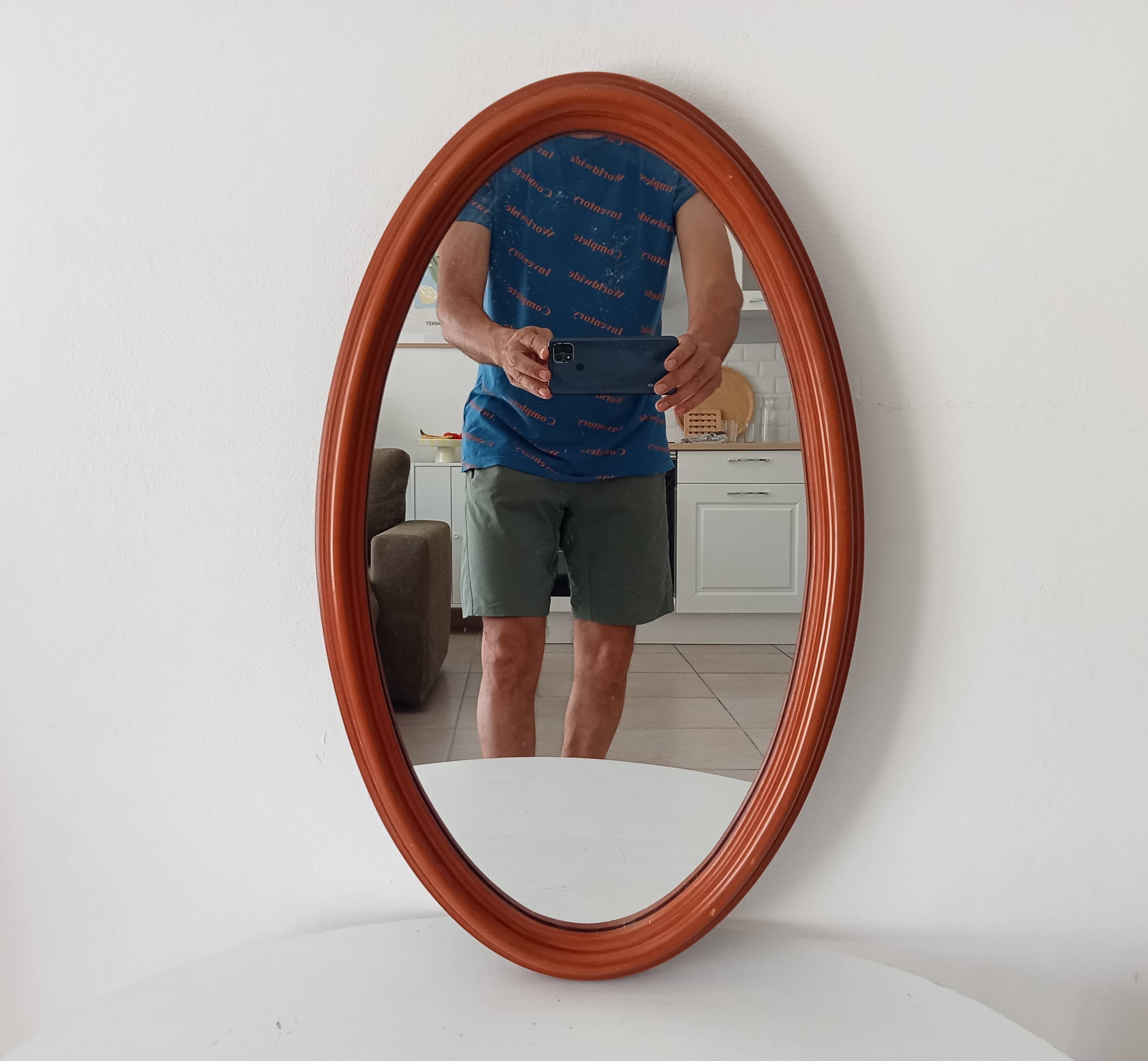Vintage oval wooden mirror "caramel" from the 1960s.