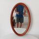 Vintage oval wooden mirror "caramel" from the 1960s.