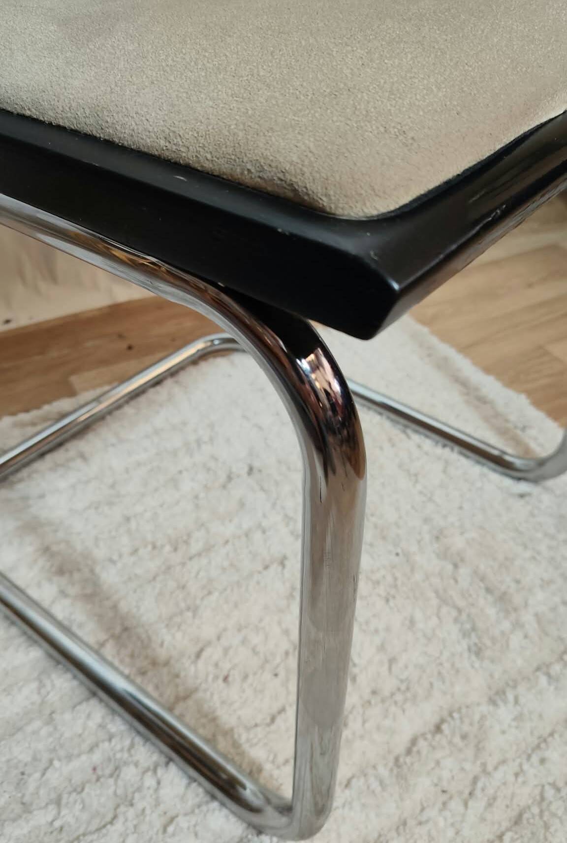 Cesca B32 chair by Marcel Breuer, upholstered in beige fabric.