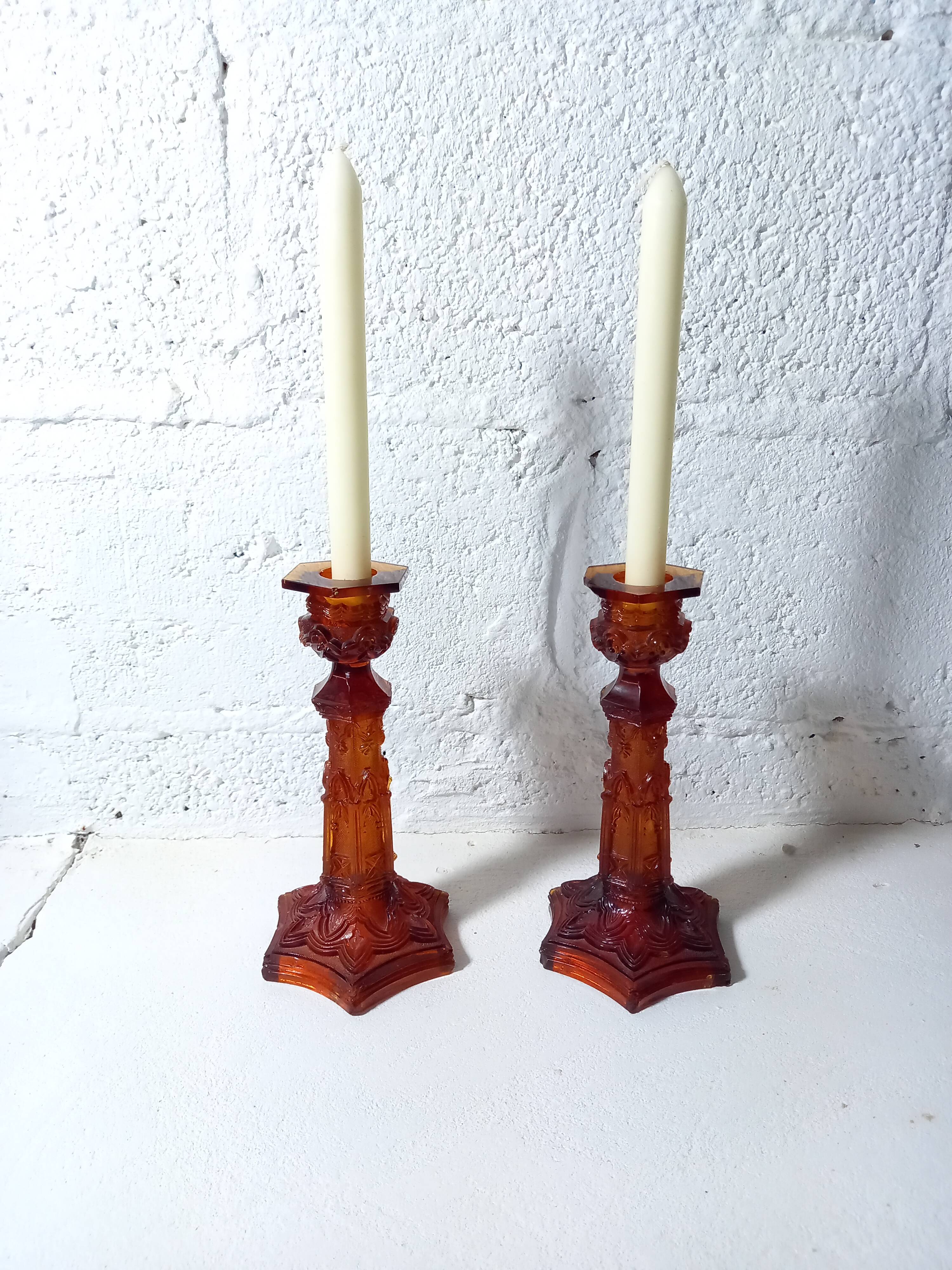 Pair of amber glass torches decorated with gothic motifs