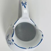 Moustiers pitcher with blue floral decoration