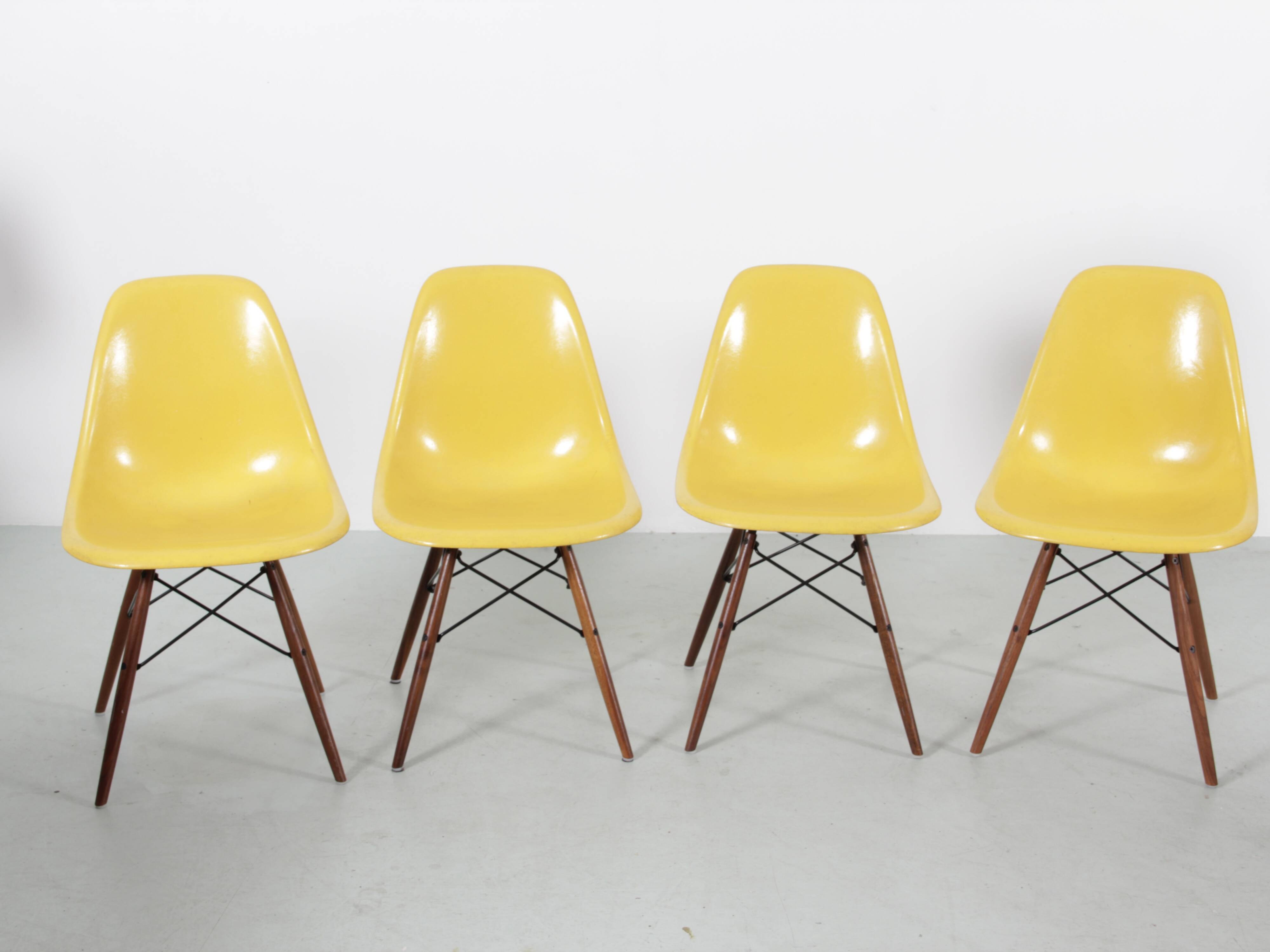 Set of 4 DSW chairs by Charles Eames - yellow fibreglass edition by Herman.