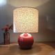 Red bedside lamp, liberty lampshade with small pink flowers.