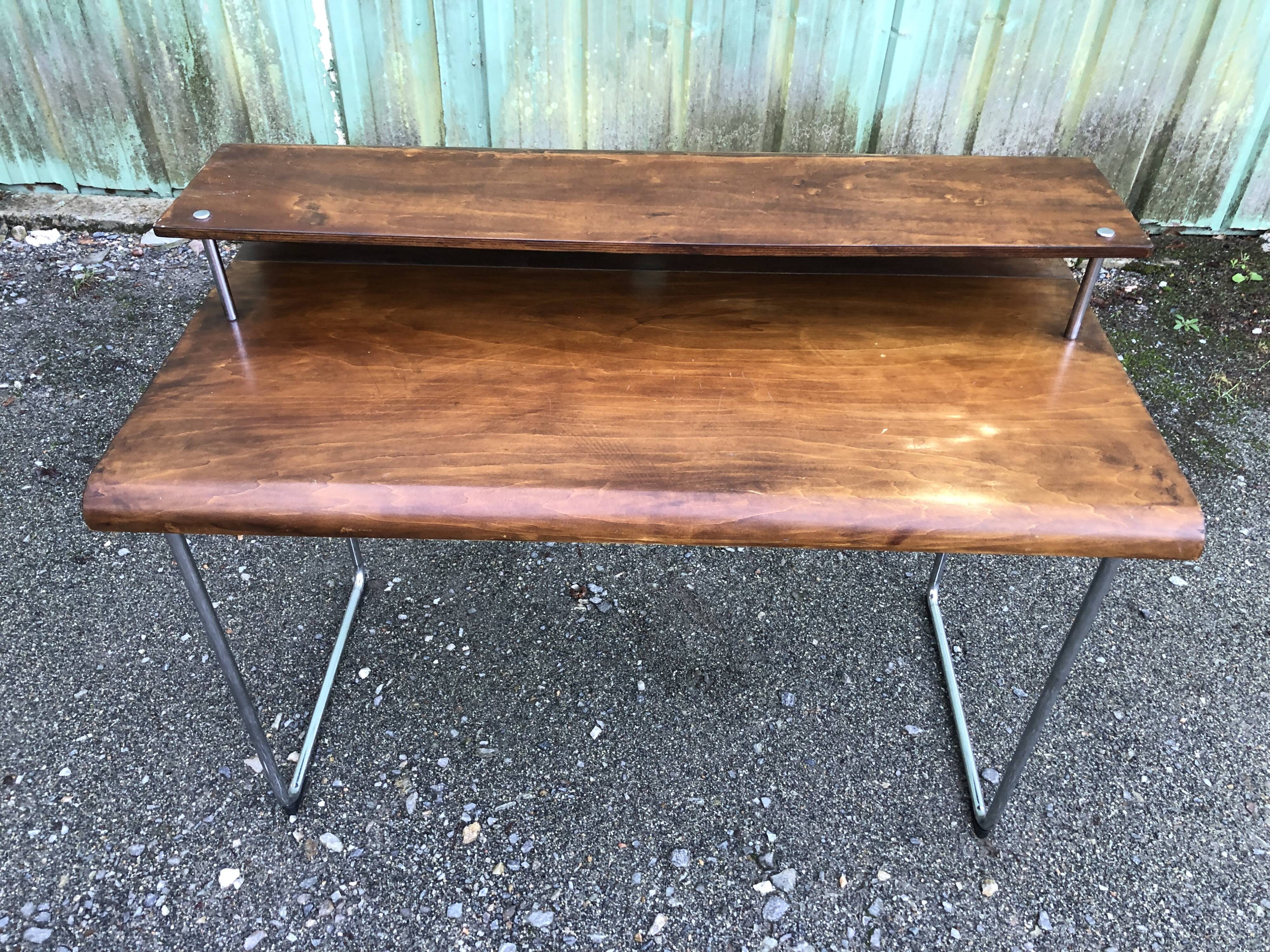 Design desk in formed glued laminated wood with chrome tubular base.