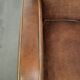 Sheepskin armchair in a light cognac colour with matching piping