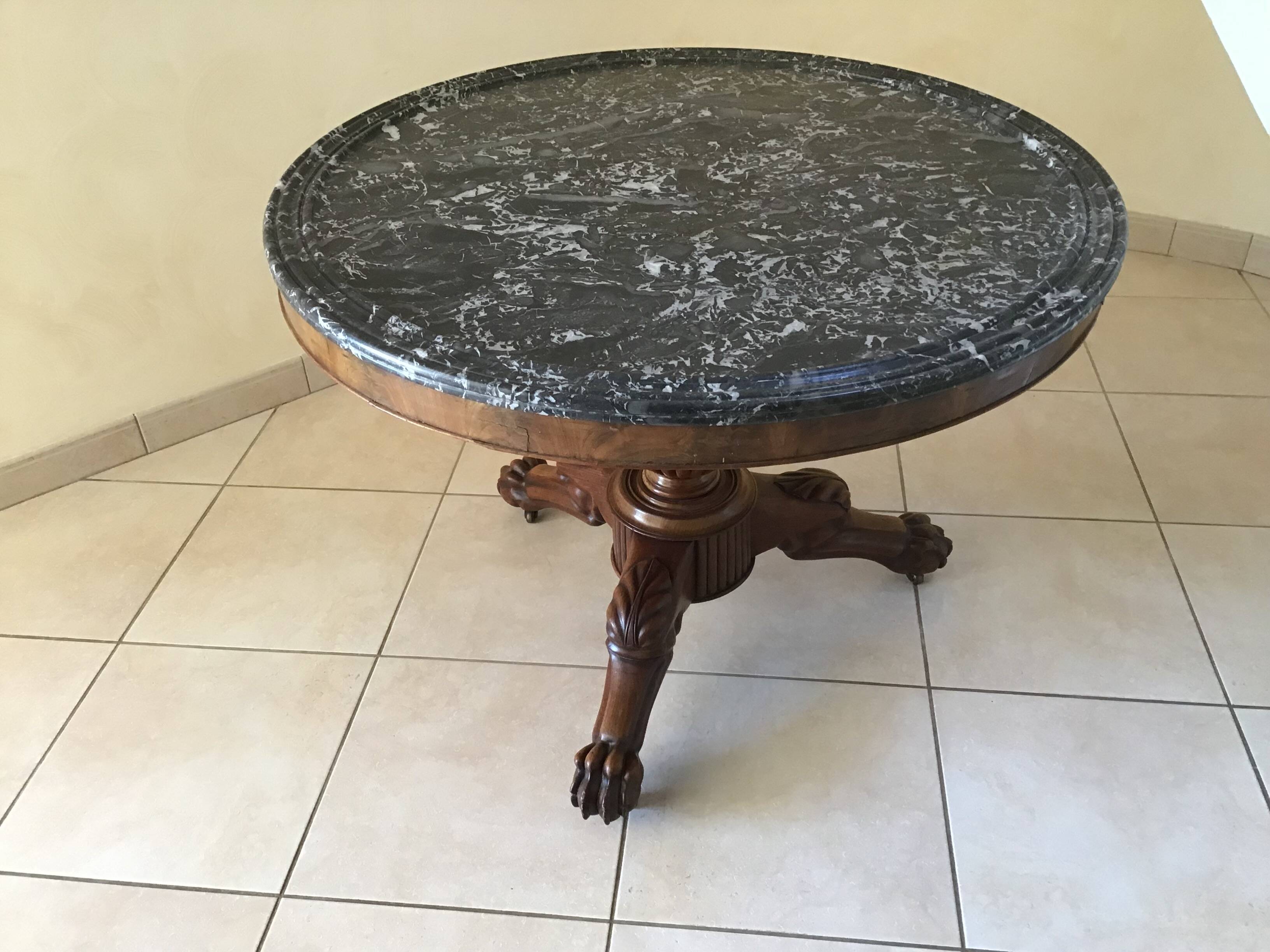 Wooden gueridon with marble, lion paw legs.