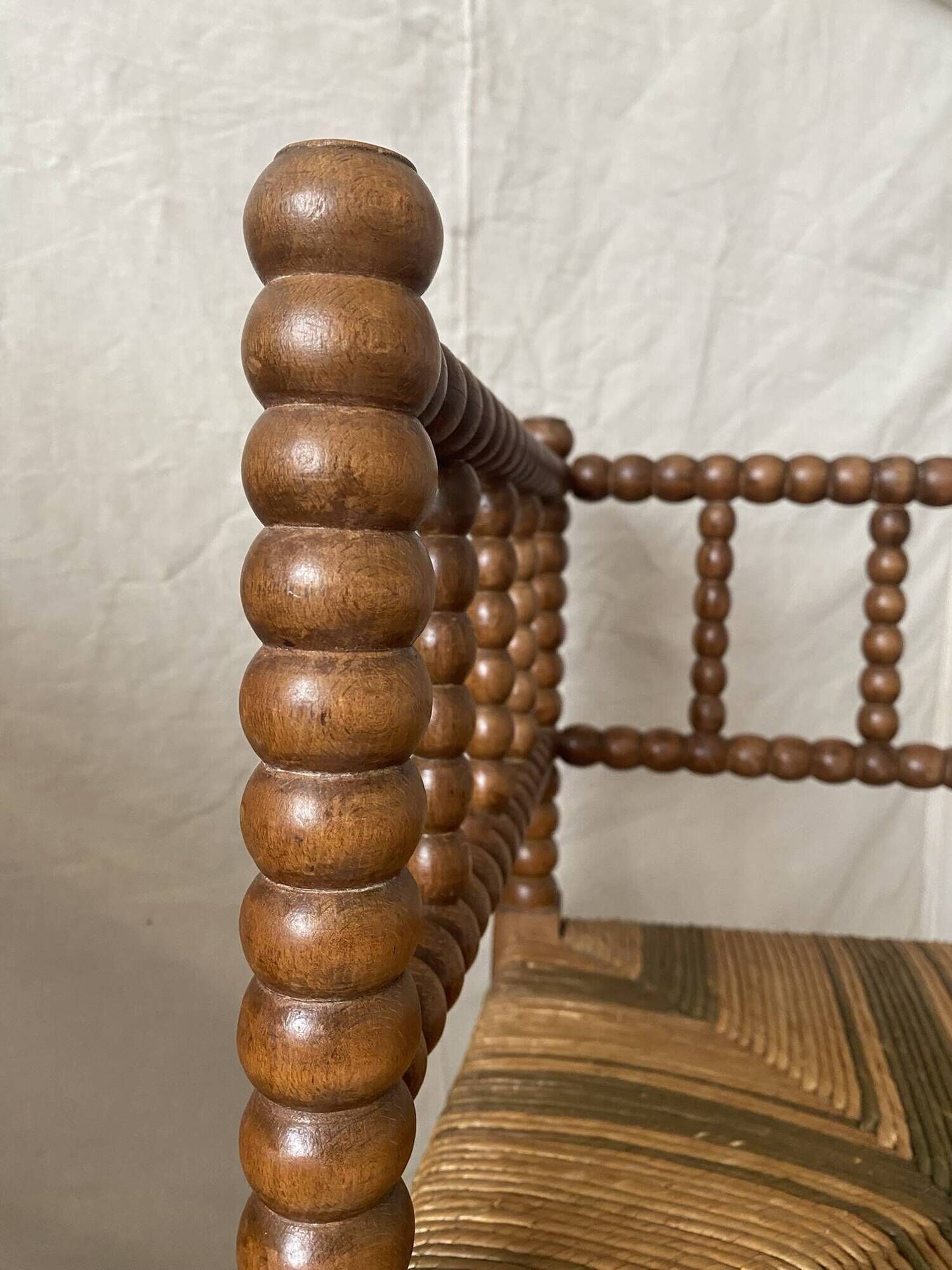 Corner chair in straw and turned wood, fireside chair.
