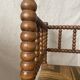 Corner chair in straw and turned wood, fireside chair.