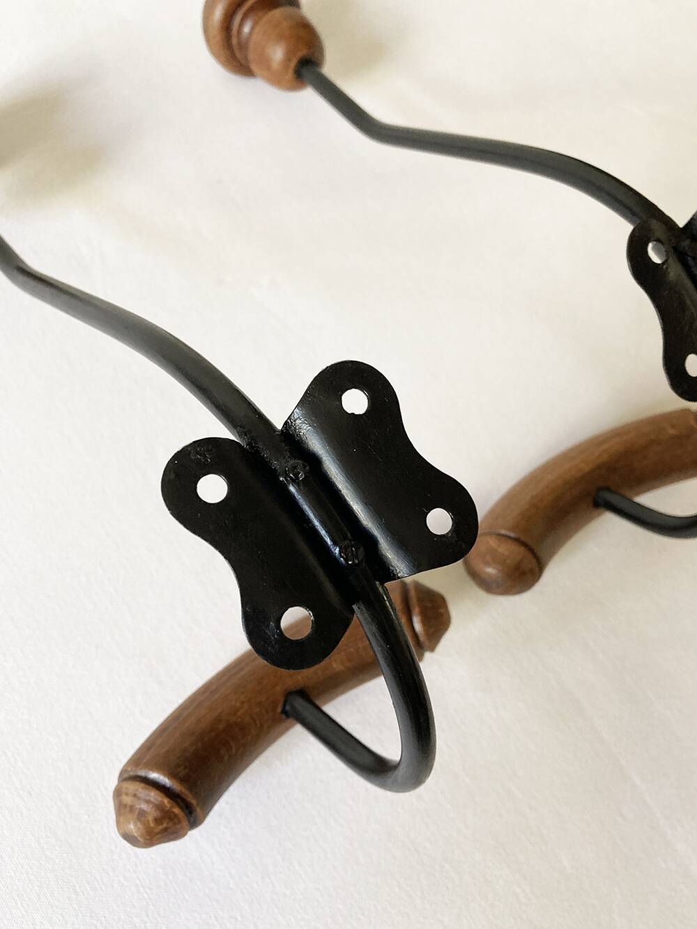 Pair of antique wooden and metal coat hooks