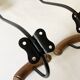 Pair of antique wooden and metal coat hooks