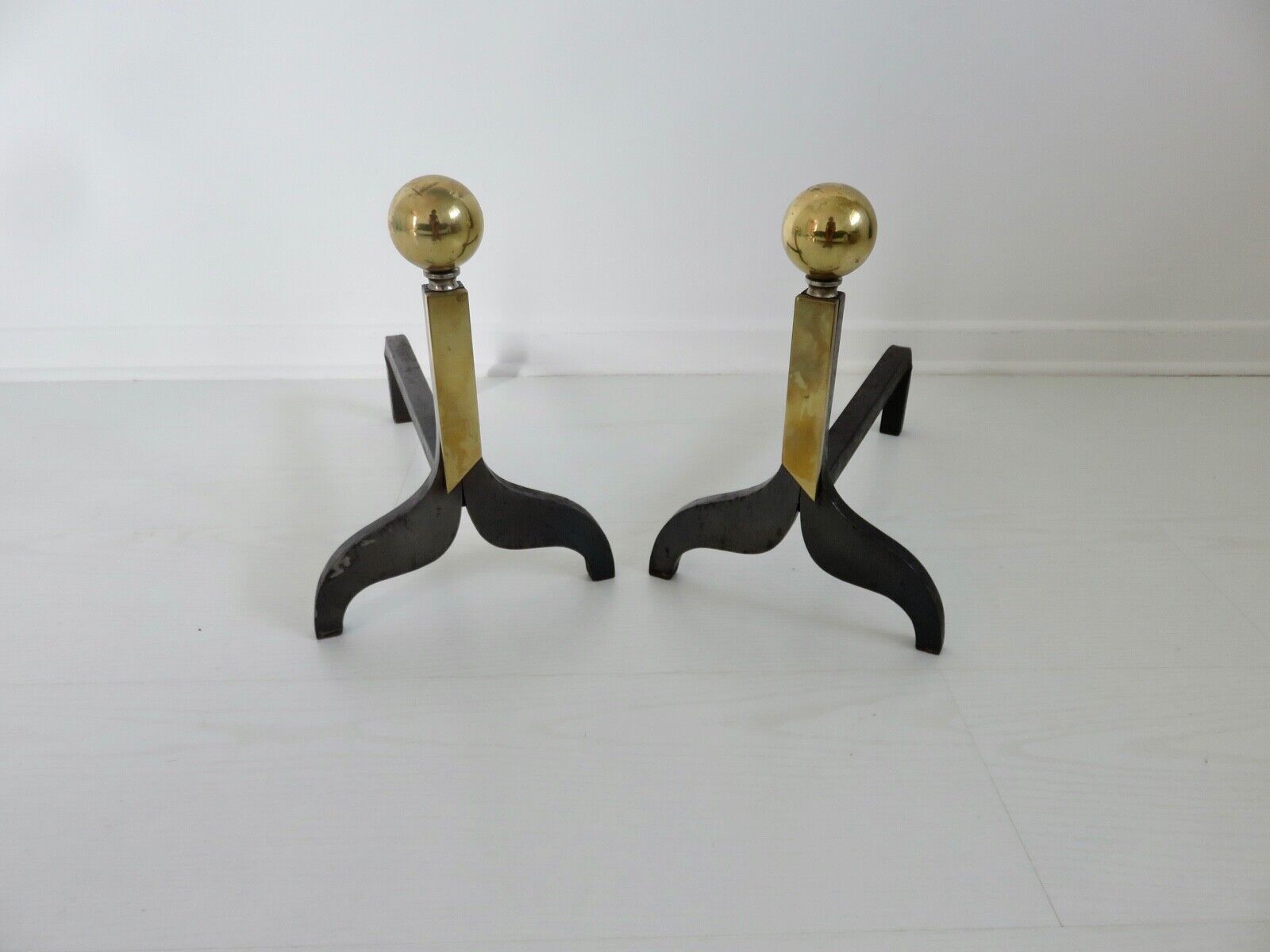 Pair of modernist steel and brass andirons