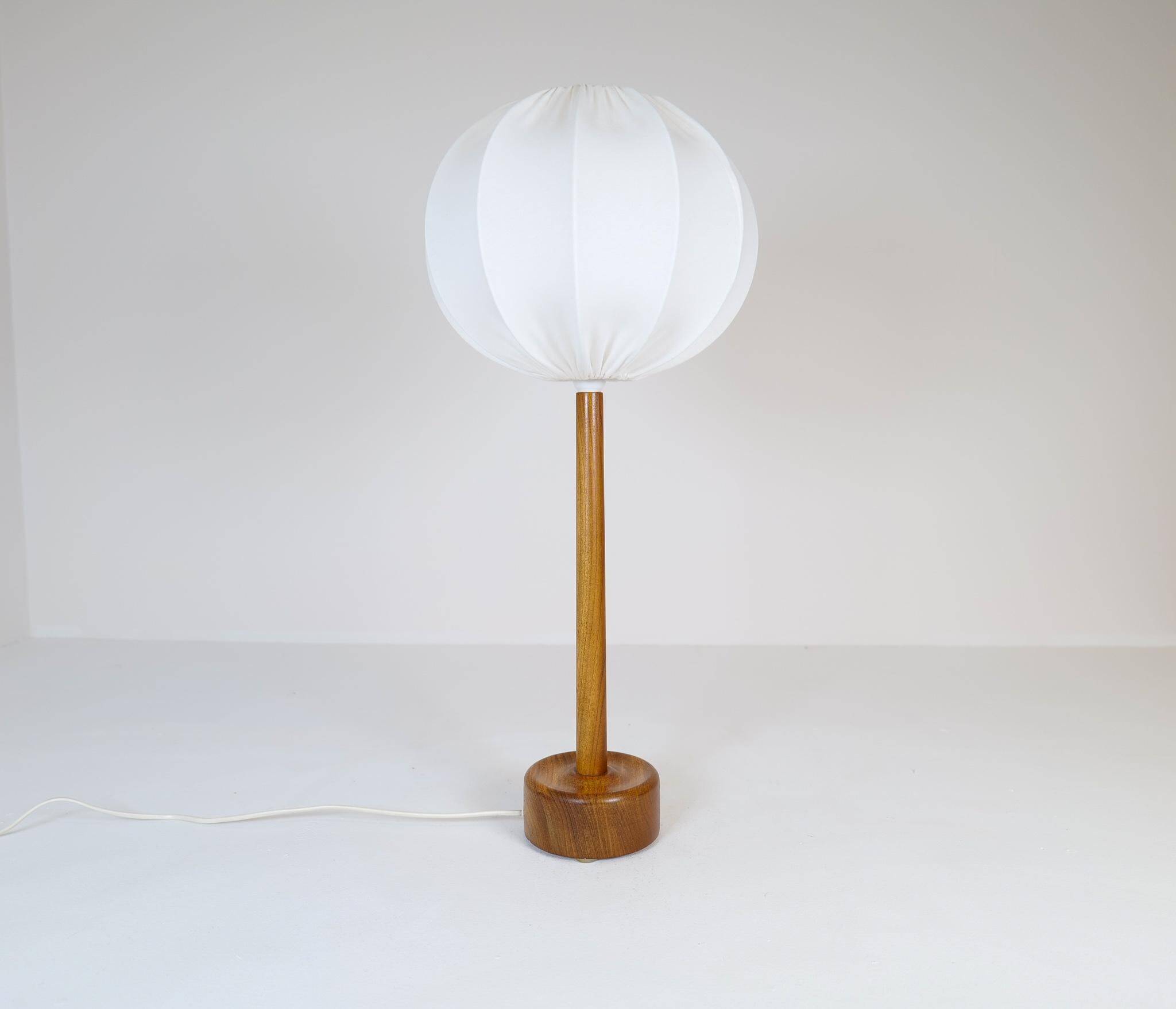 Mid-century solid teak table lamp from the 1960s Sweden.