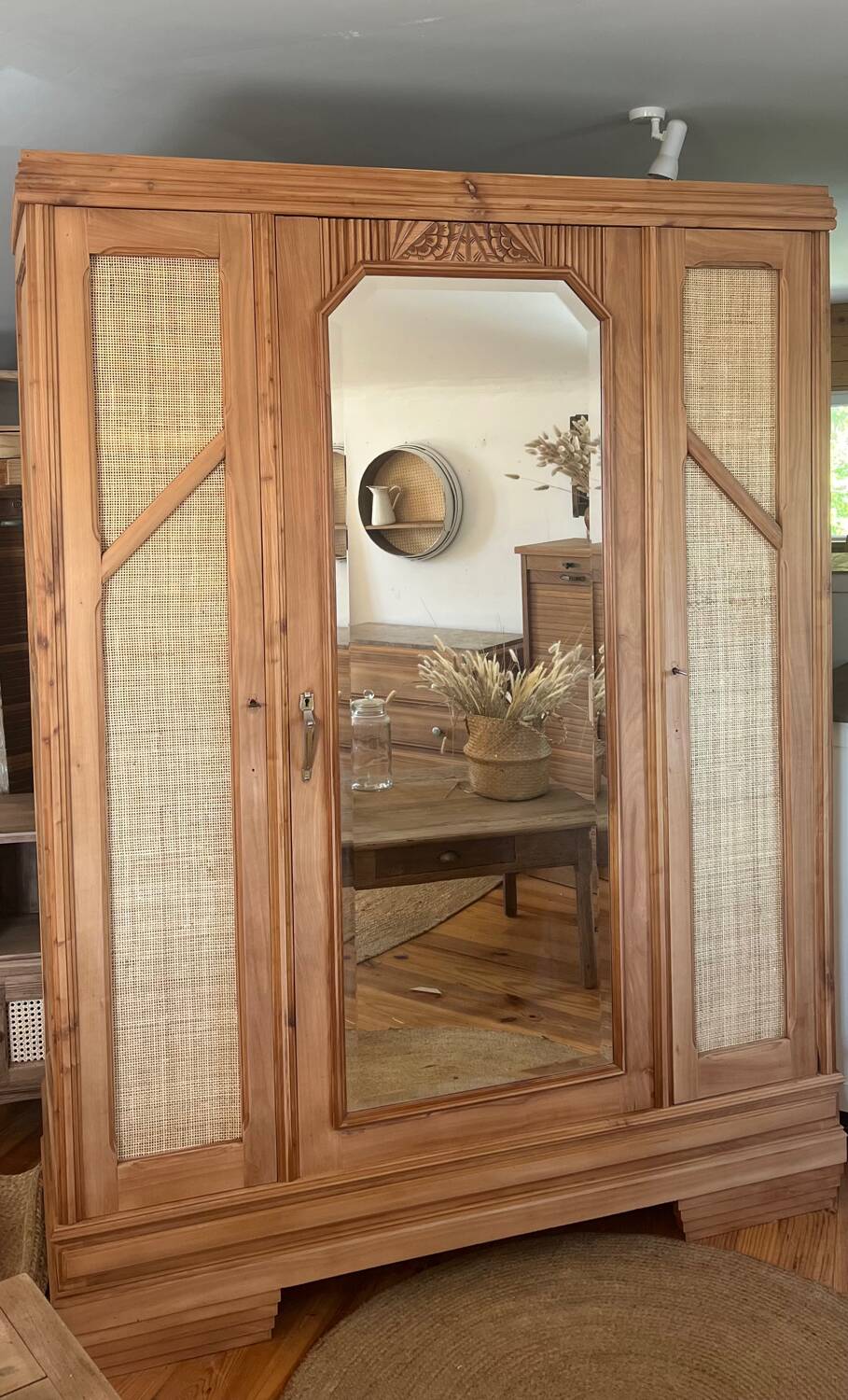 Large antique wardrobe made of solid raw wood and natural caning.