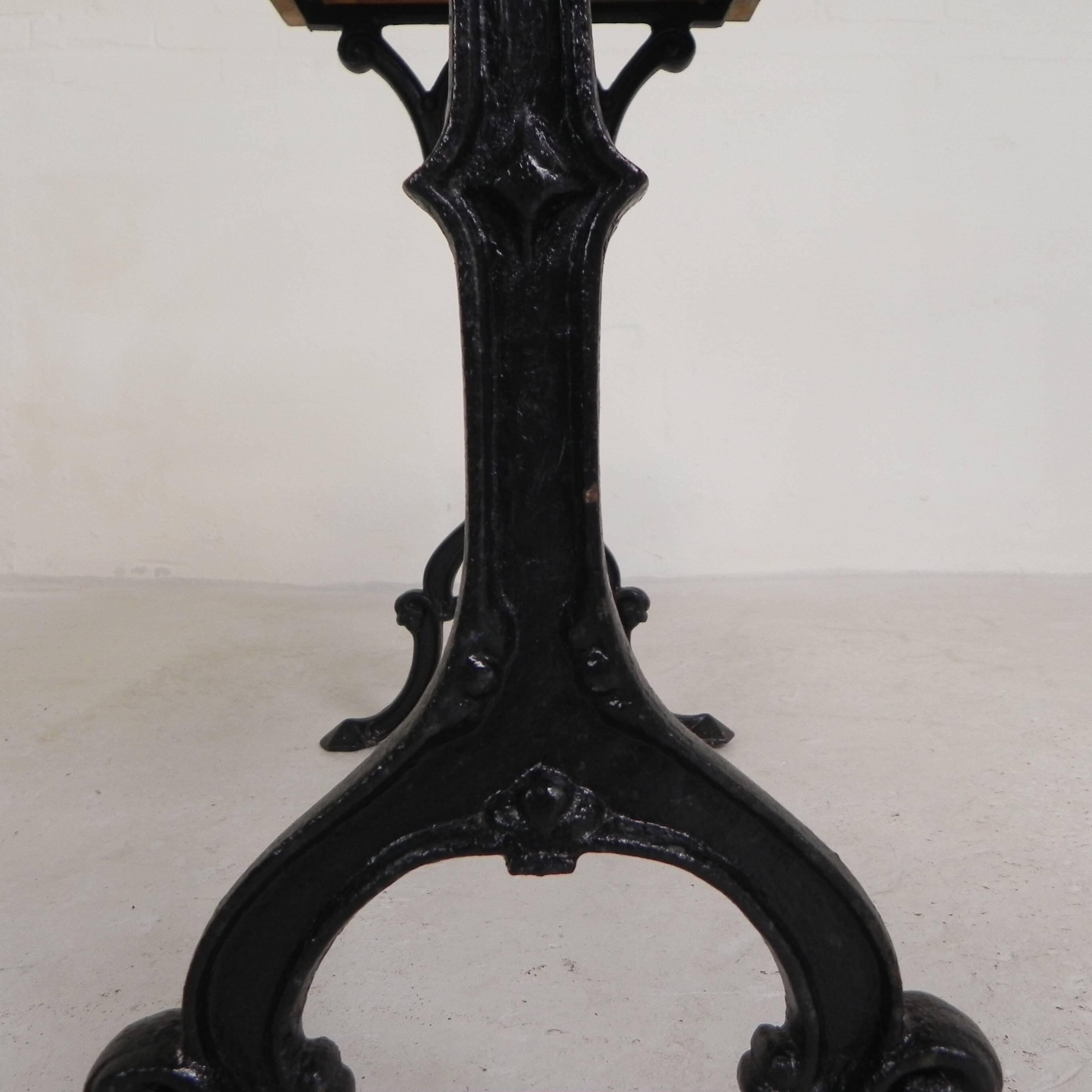 Bistro table with an oak top on a cast iron base, 1930s.