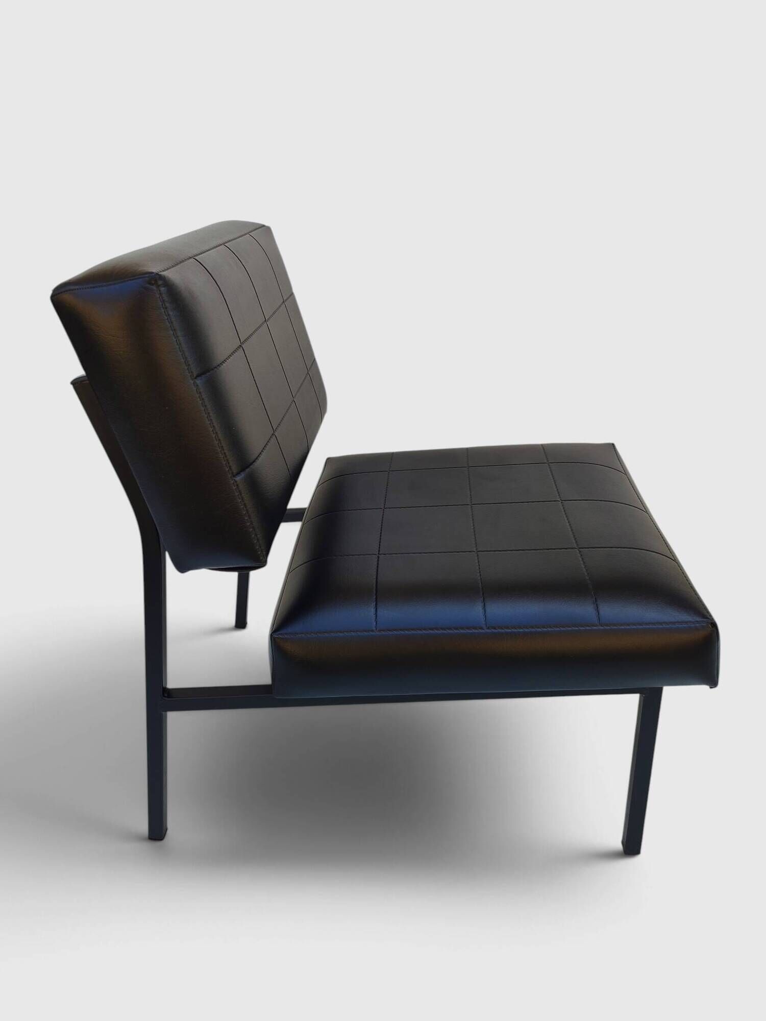 Modernist armchair in black faux leather and metal – 1960s