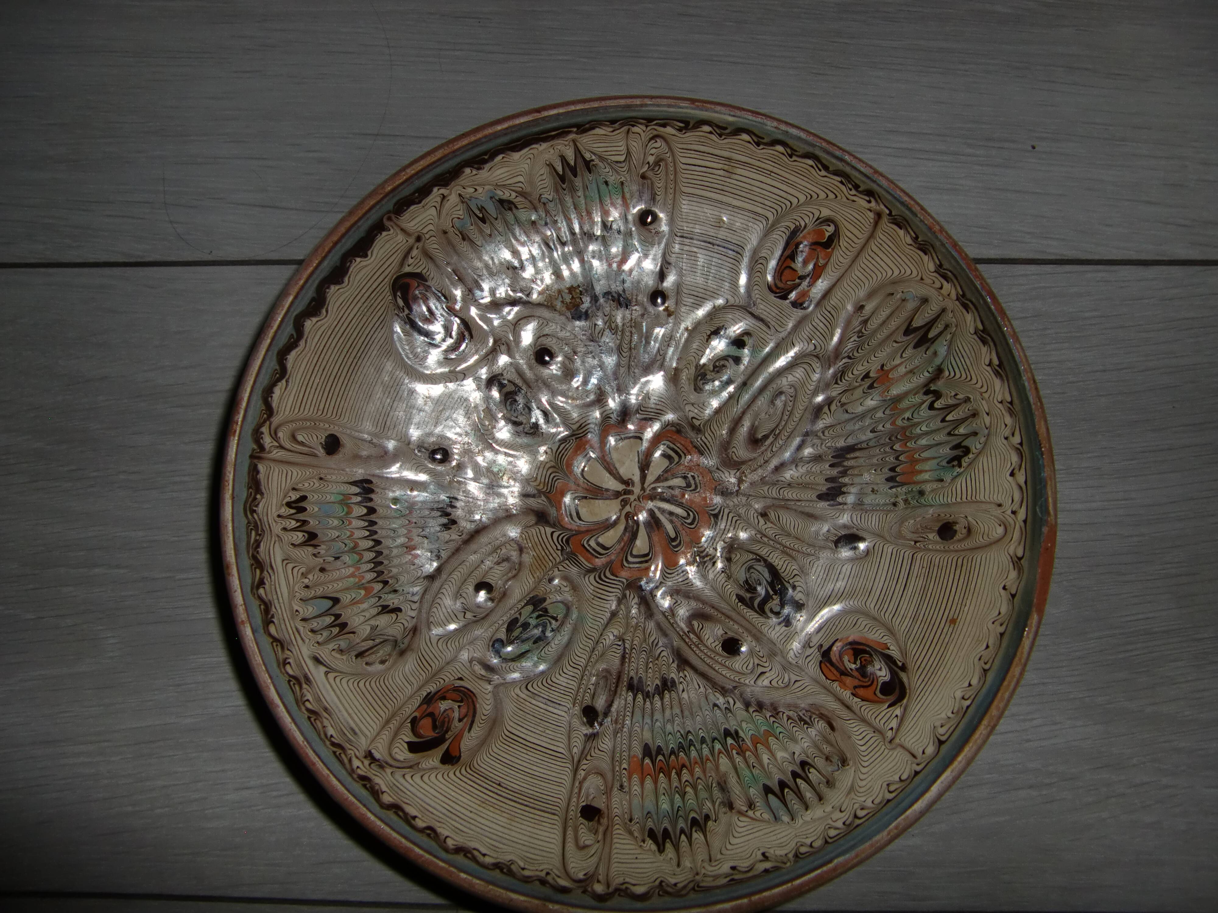 Hand decorated terracotta plate