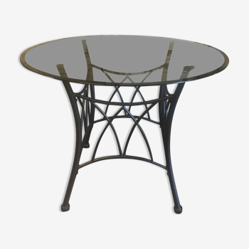 Round table with metal legs and smoked glass