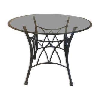 Round table with metal legs and smoked glass