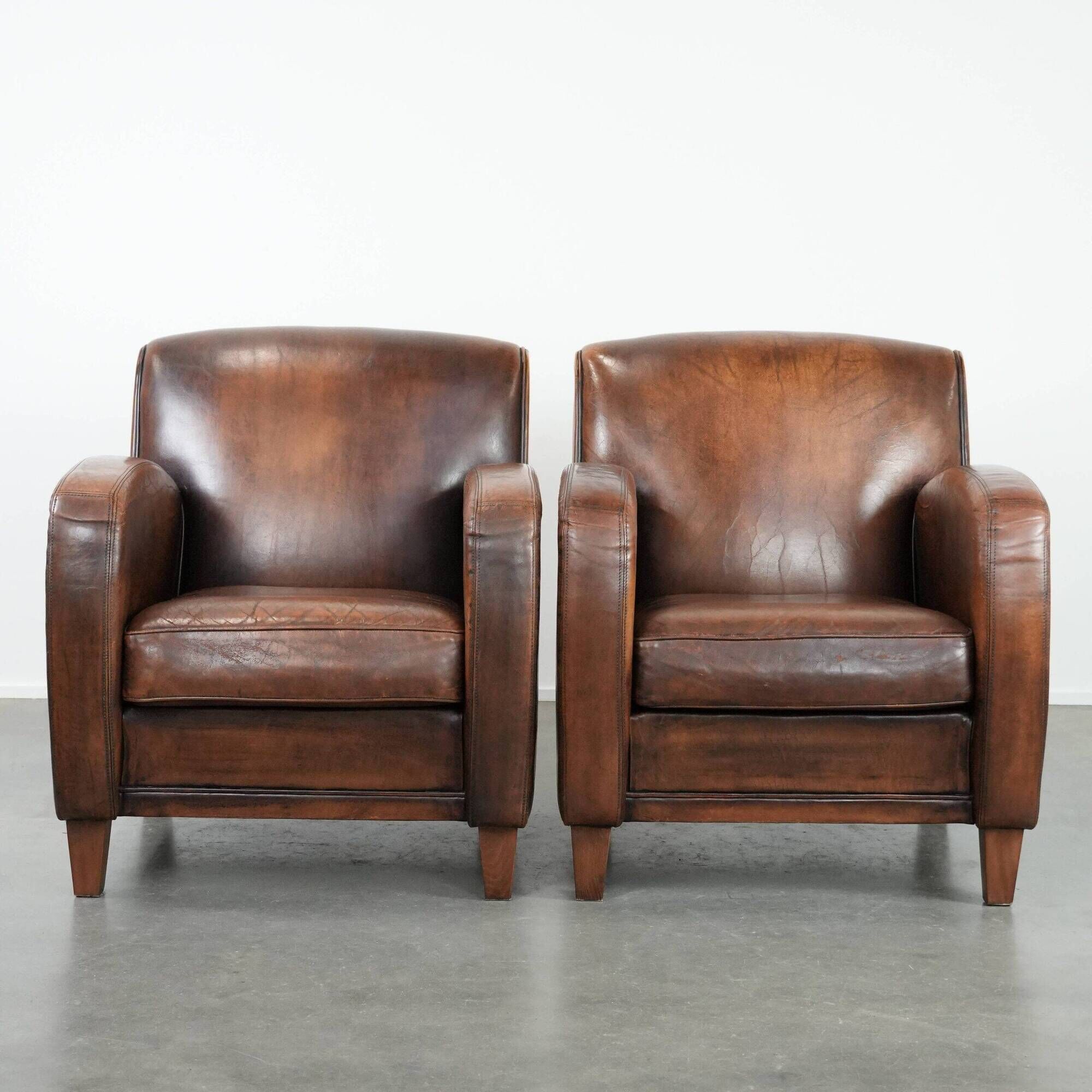 Characterful set of two vintage sheepskin armchairs with beautiful colours