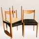 Set of 6 modernist chairs with black faux leather seats.