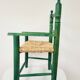 Small vintage children's chair in wood and green straw