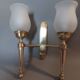 Neoclassical Torch two-arm wall lamp in solid brass, circa 1940