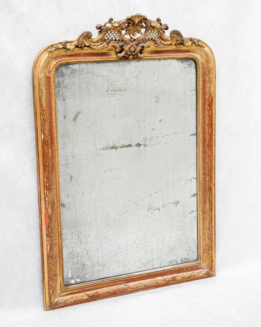 19th-century Louis-Philippe mirror with patina and pediment.