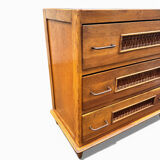 Vintage 1970s chest of drawers: wood and rattan, splayed legs.