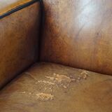 Fauteuil design en cuir de mouton vintage confortable avec un look robuste