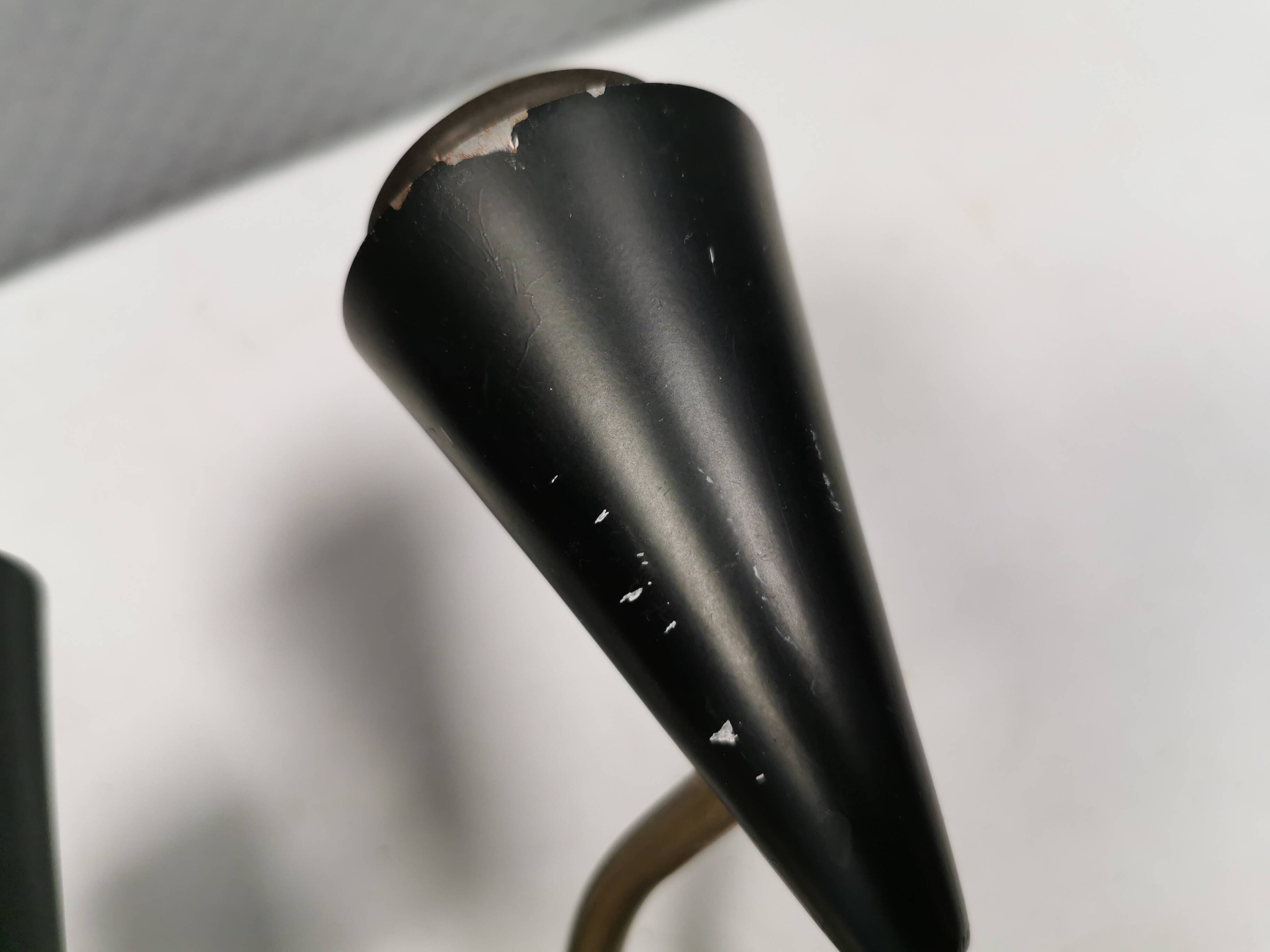 A set of wall lamps in black lacquered metal with brass details