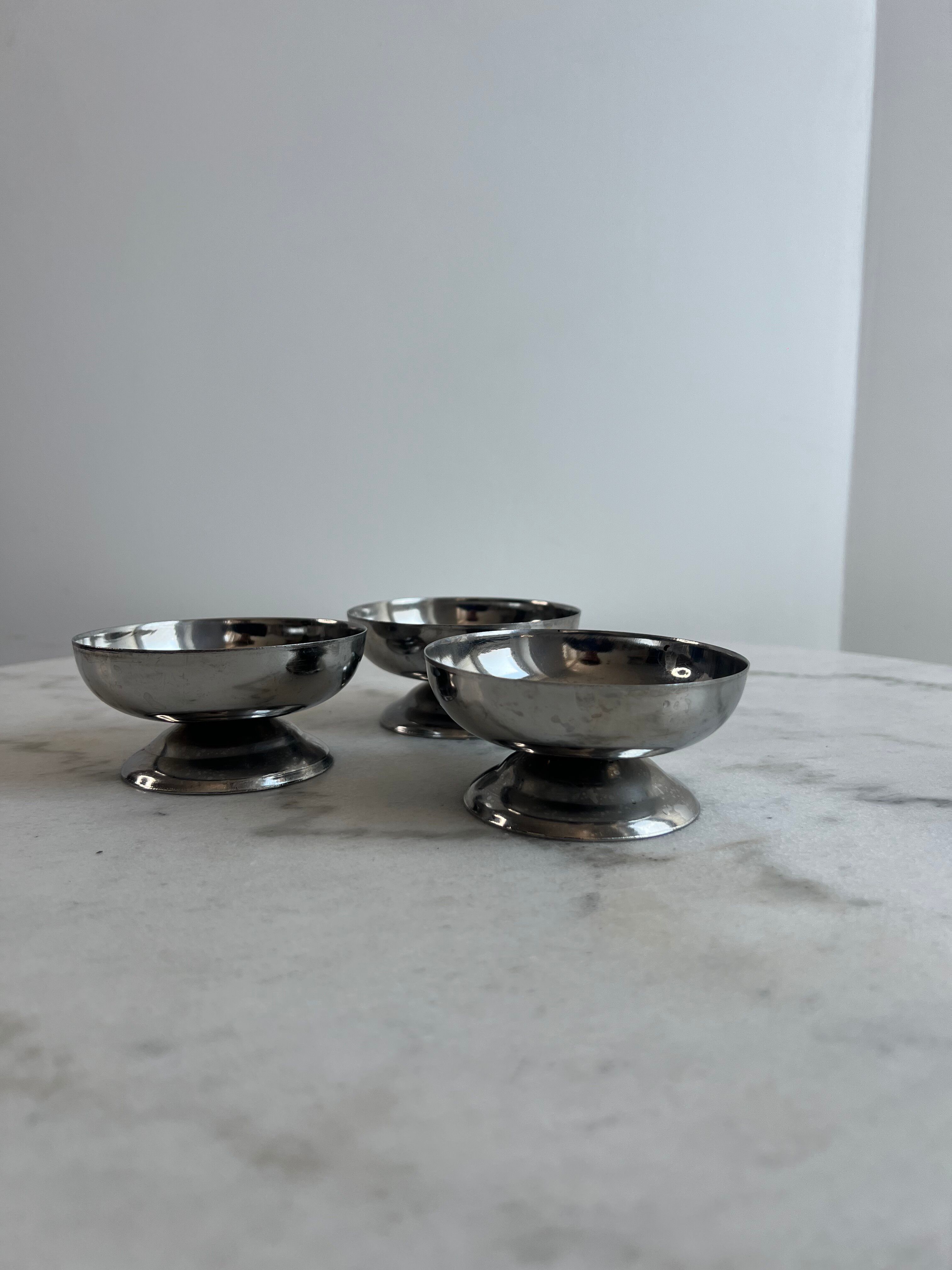 Set of 3 stainless steel dessert bowls on stands.
