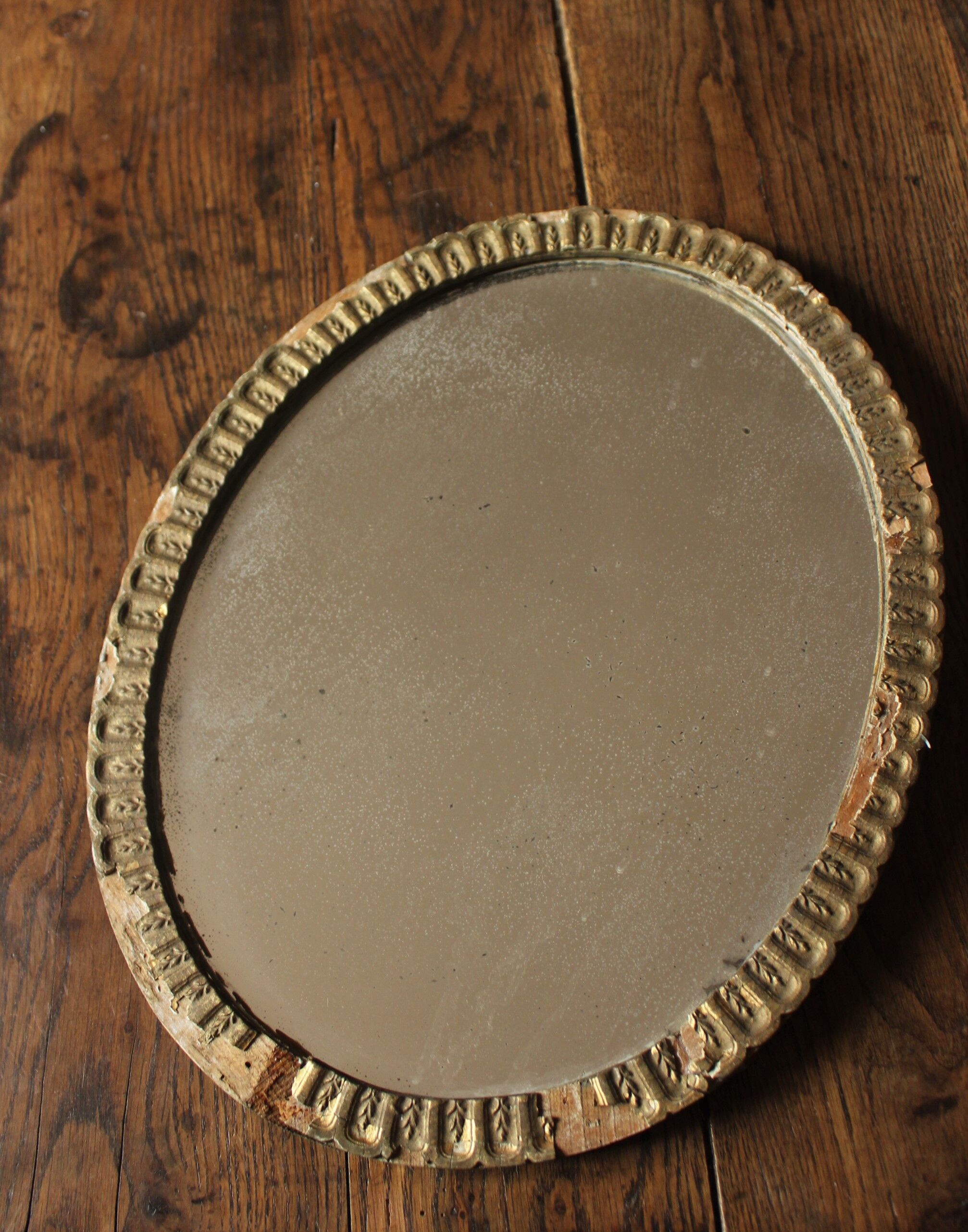 Old oval mirror gilded wood mercurized