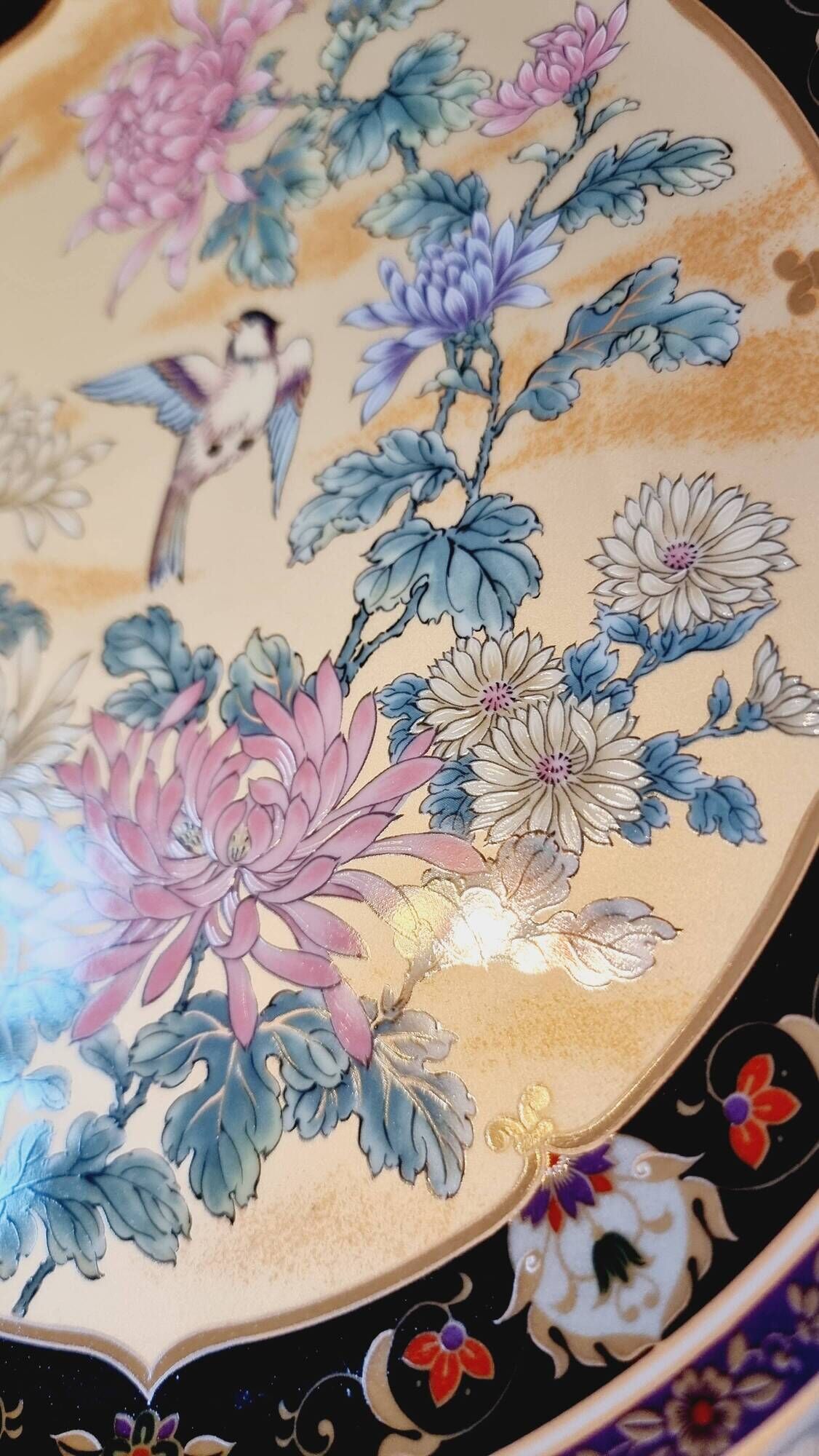 Vintage Japanese decorative plate with chrysanthemum and bird patterns.