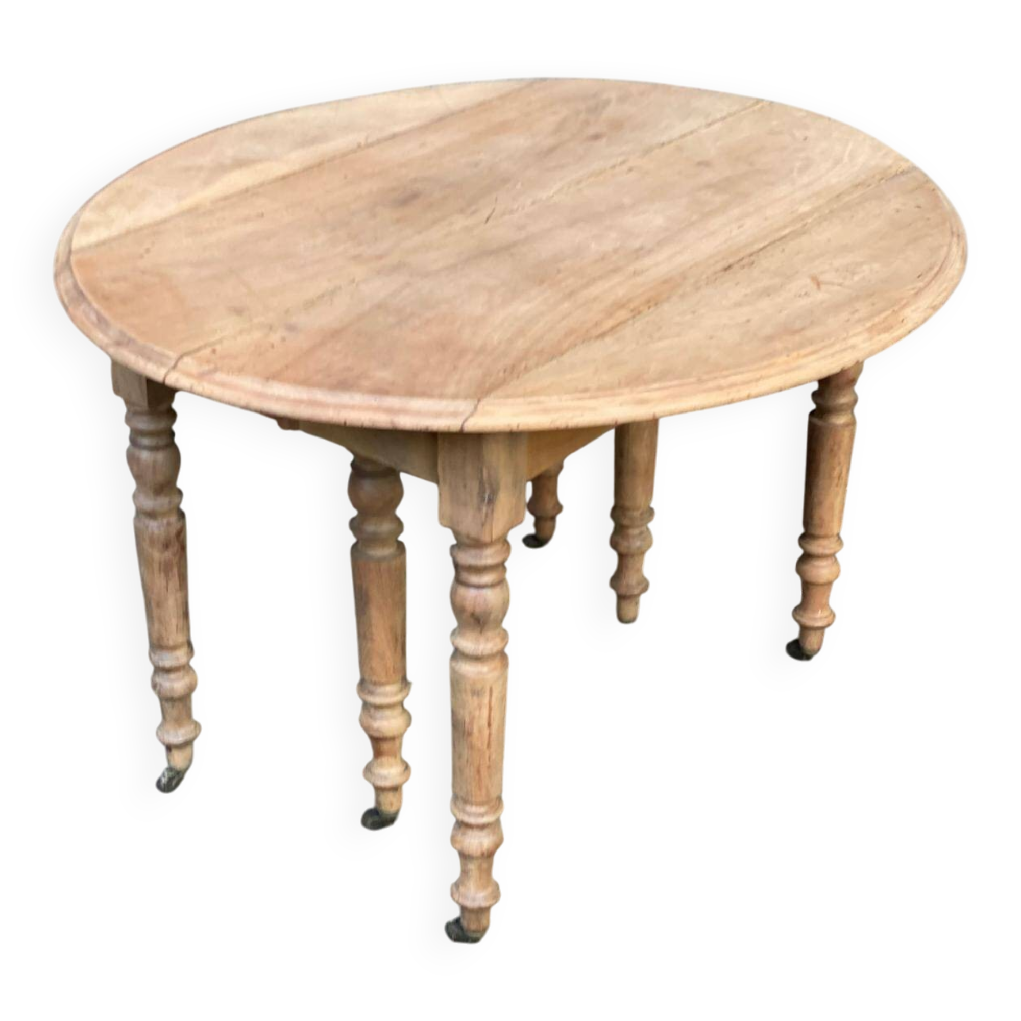 Renovated round extendable dining table with leaves made of solid wood.