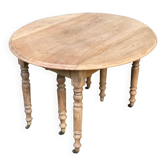 Renovated round extendable dining table with leaves made of solid wood.