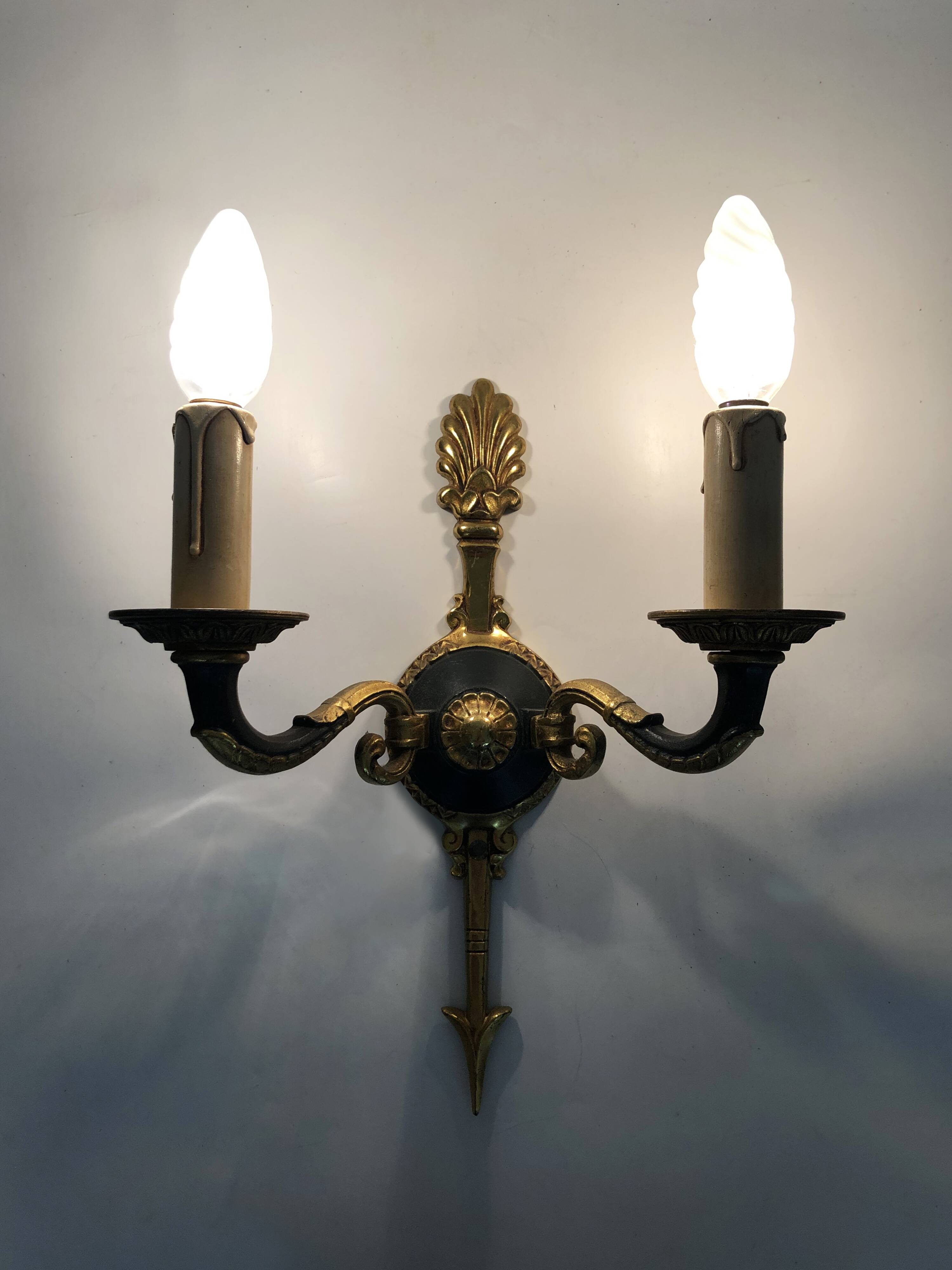 Pair of wall sconces in the Empire style with double lights in bronze.
