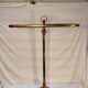Old golden brass towel rack on baroque style foot