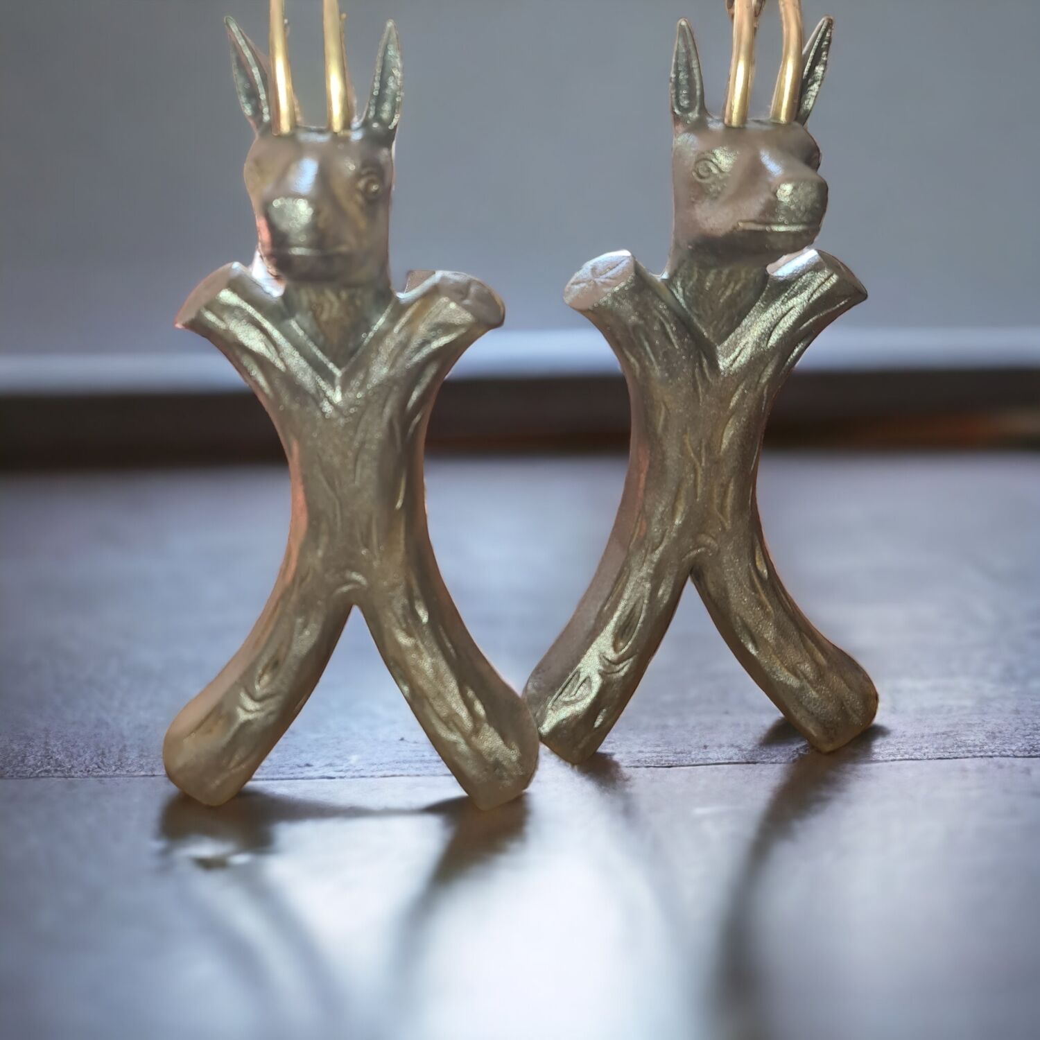 Zoomorphic buff brass and cast iron andirons