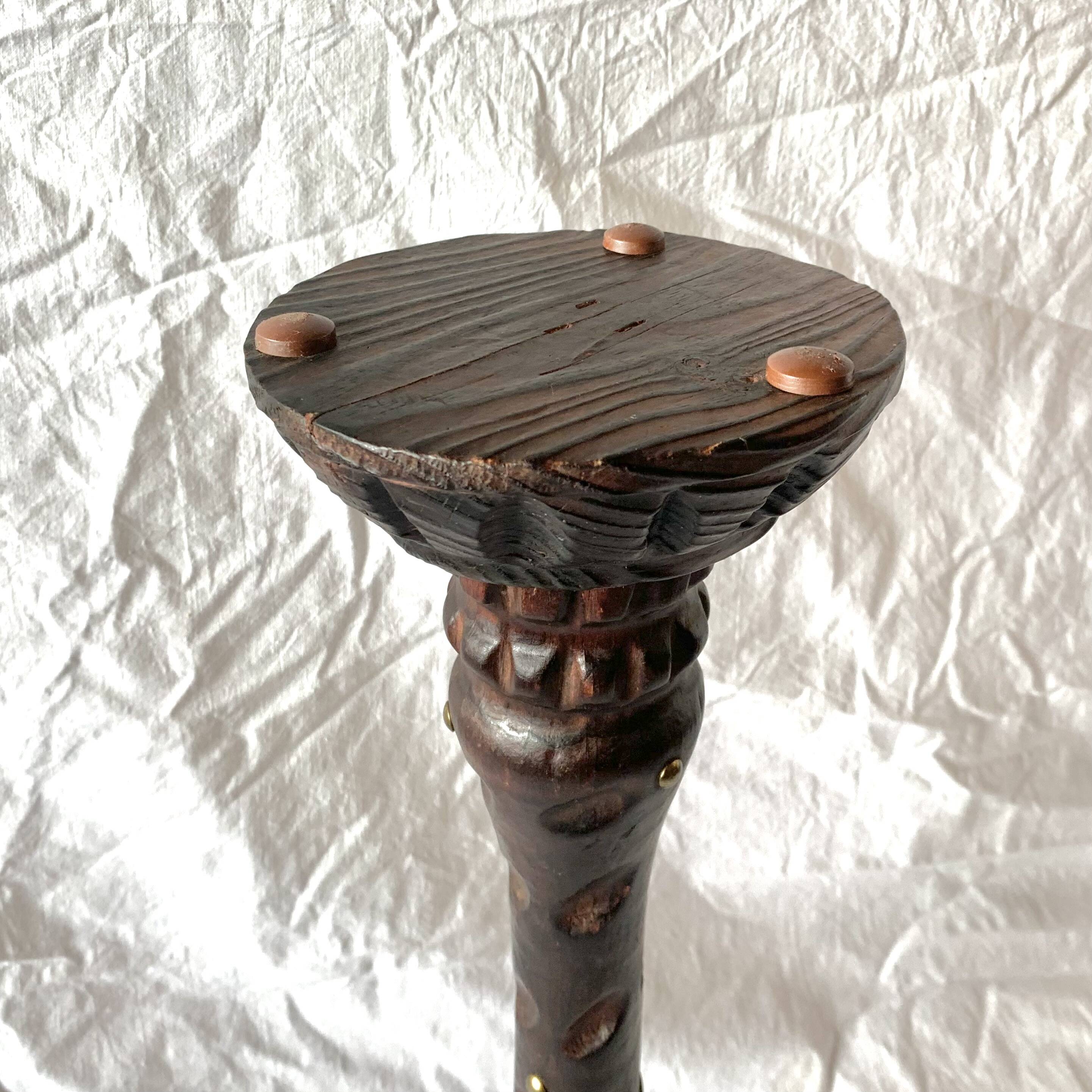 Old ashtray on carved wooden stand