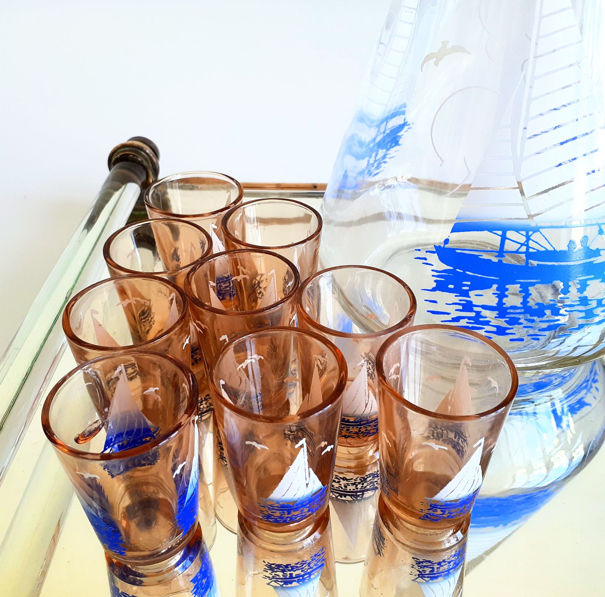 Carafe and 9 liquor glasses decorated with sailboats