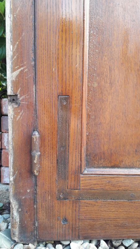 Oak entrance door and its frame and transom, wrought iron gates