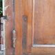 Oak entrance door and its frame and transom, wrought iron gates